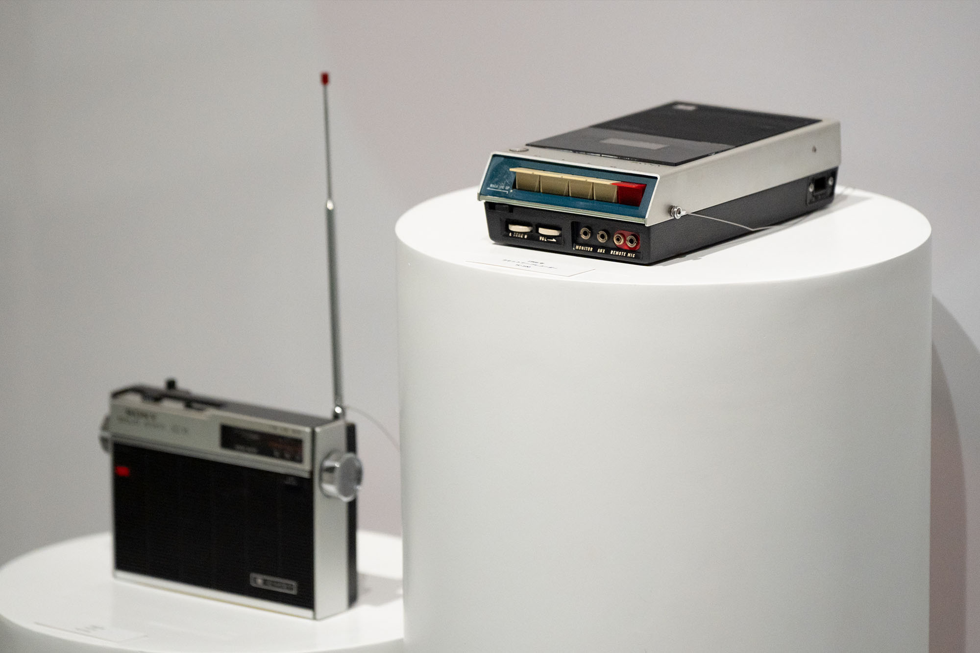 Display of Sony audio devices. Radios and recording equipment are placed on pedestals, introducing products from different periods.
