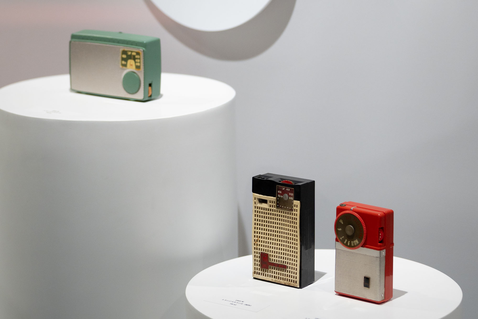 Display of compact radios. Multiple devices are arranged on pedestals, allowing comparison of design and specifications.