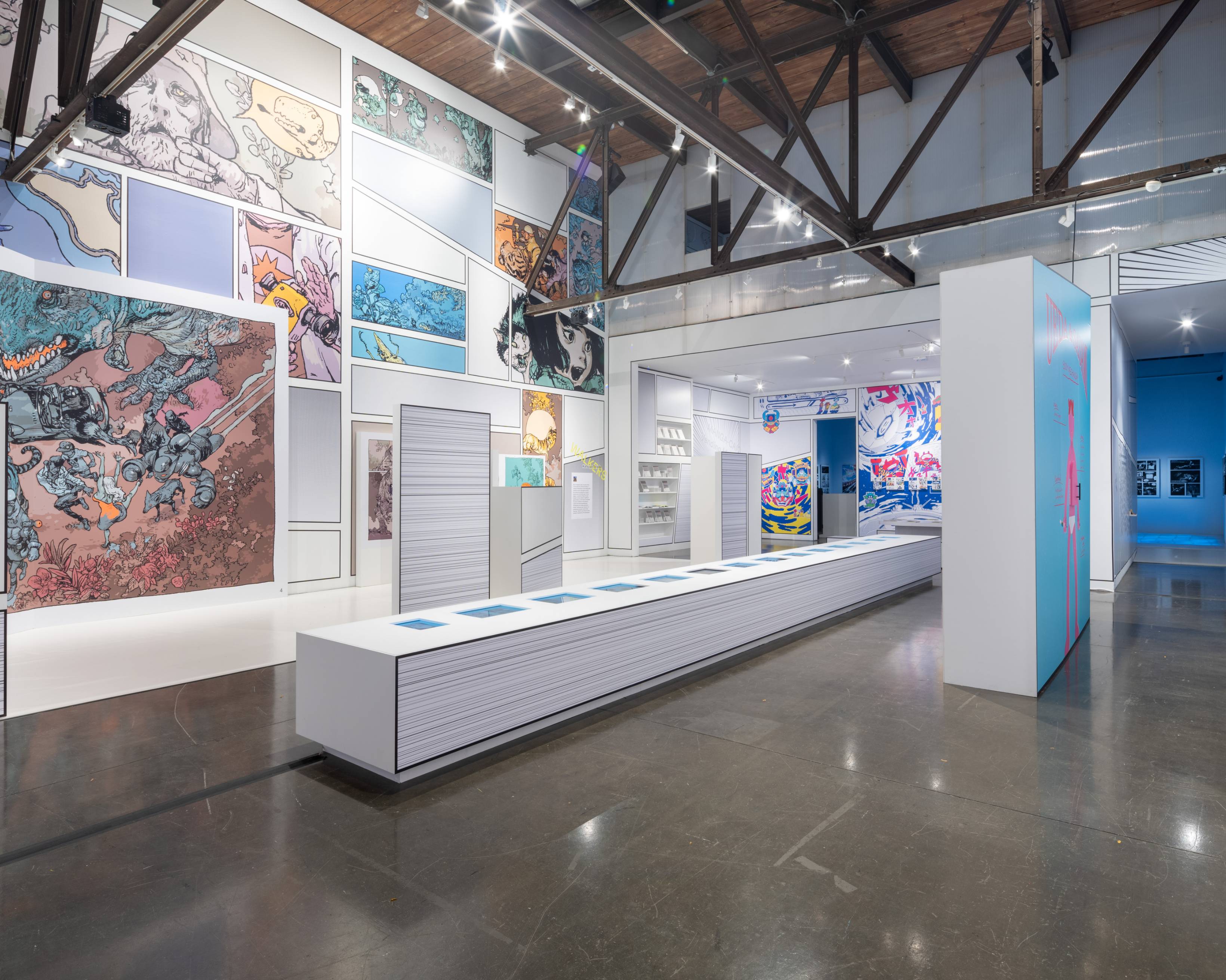 内観。寺田克也、ますだみく、たかくらかずき、一乗ひかる、millennium paradeの作品がそれぞれのゾーンに展示されている。