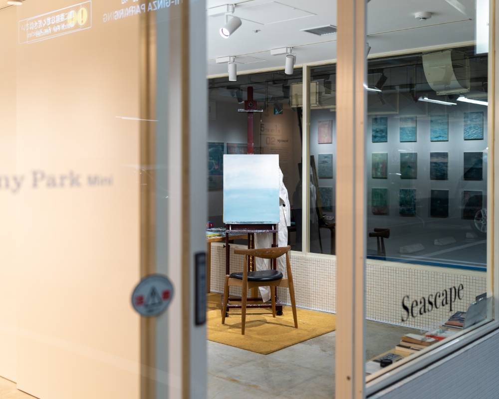 外観。展示スペースにはイーゼルに立てられた絵画と椅子が置かれているのが、入口越しにわかる。