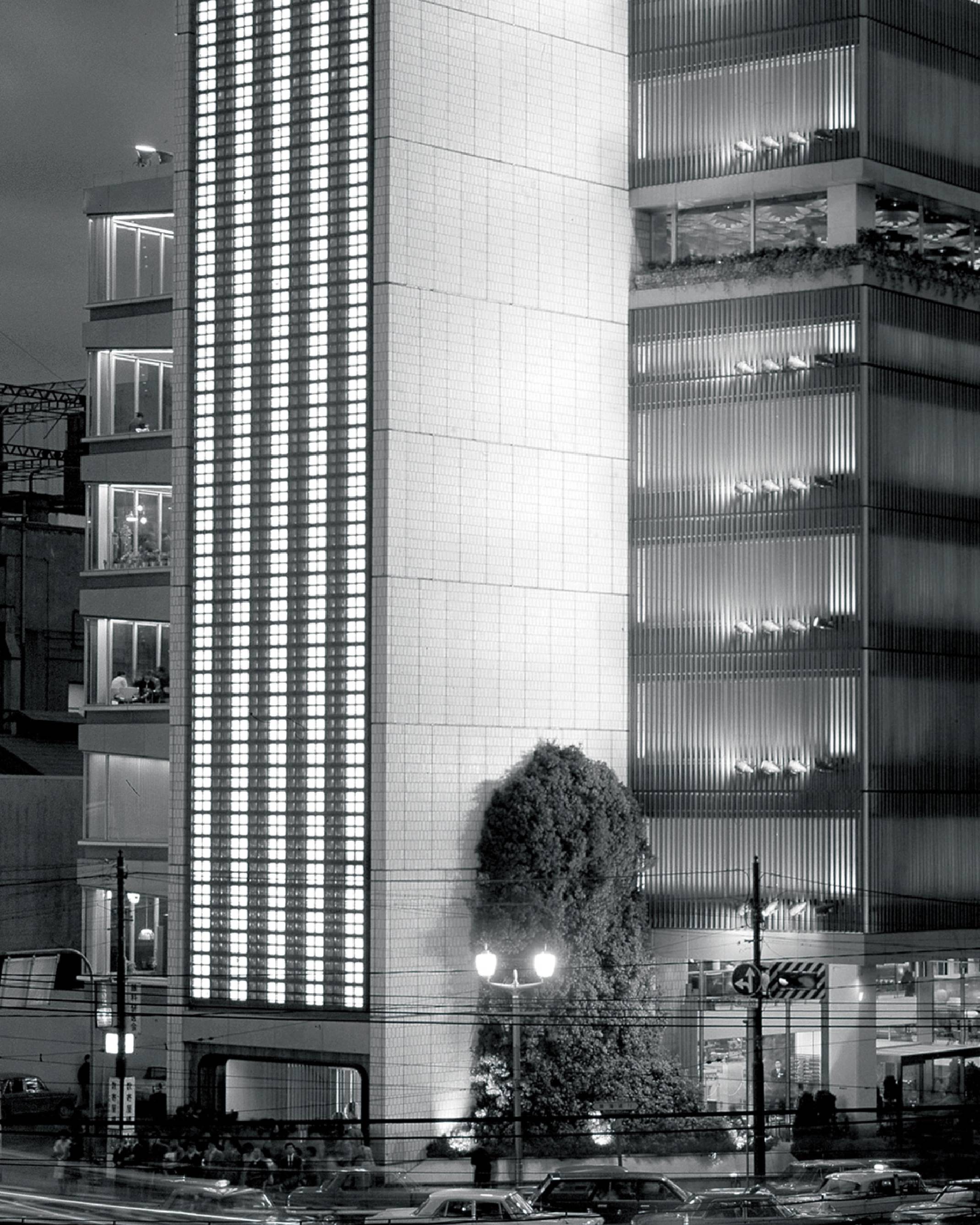 Bird’s eye view. The Sony Building at night, around when the company was founded. A large tree stands on a corner of the grounds.